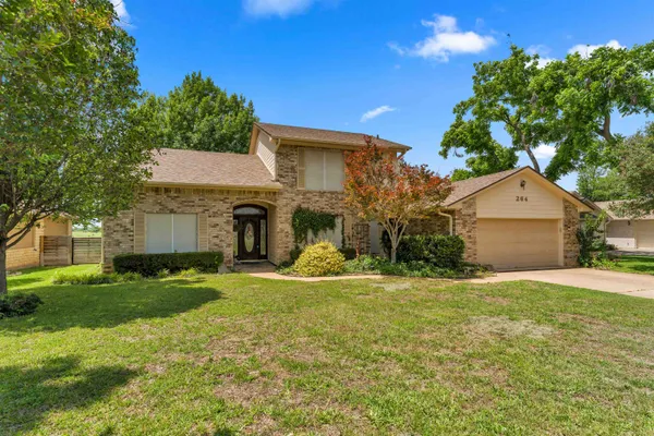 a view of a house with a yard and tree s