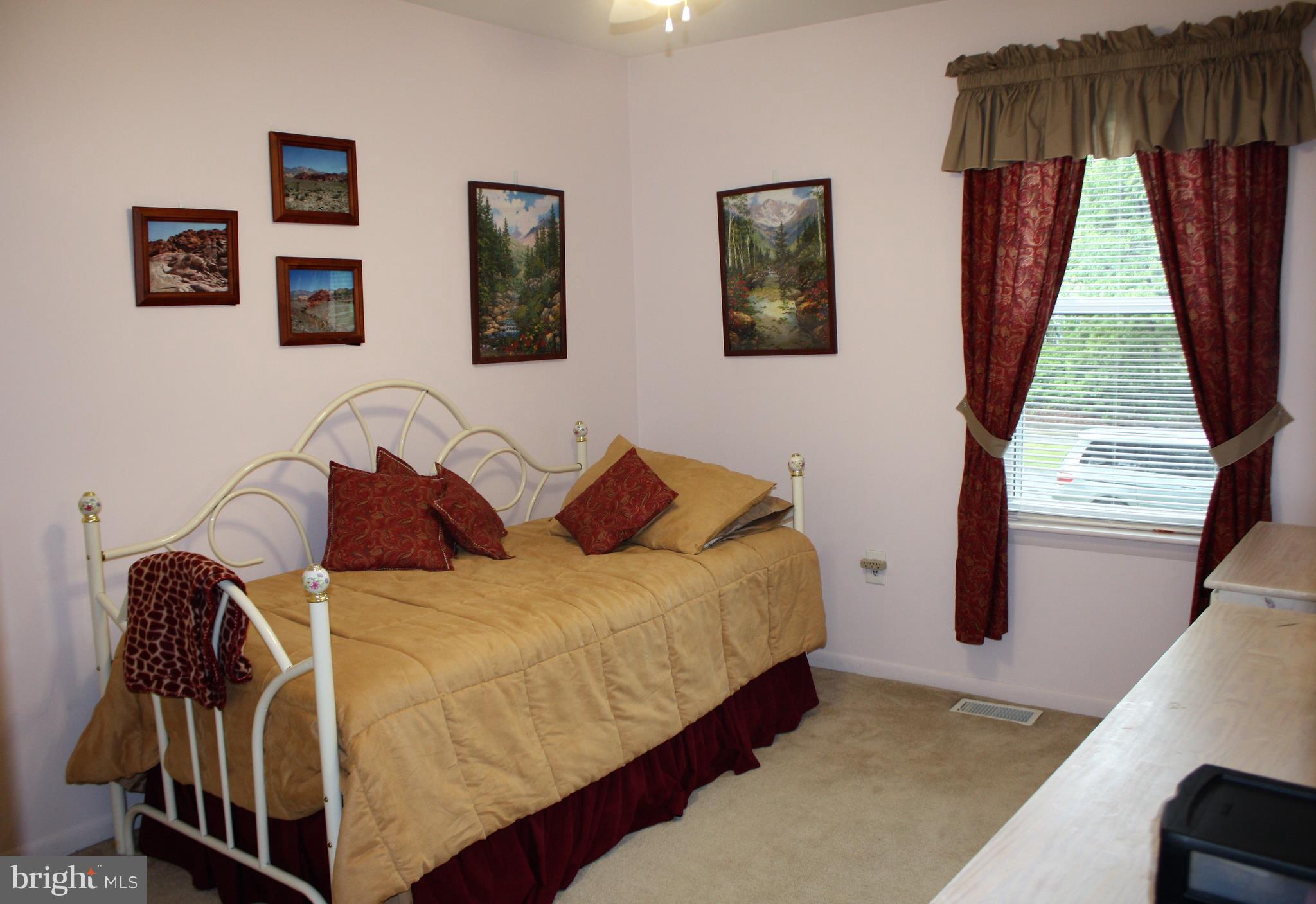 7805 Redwood Tree Road Severn, MD 21144 - Photo 14 of 20 a bedroom with a bed and window