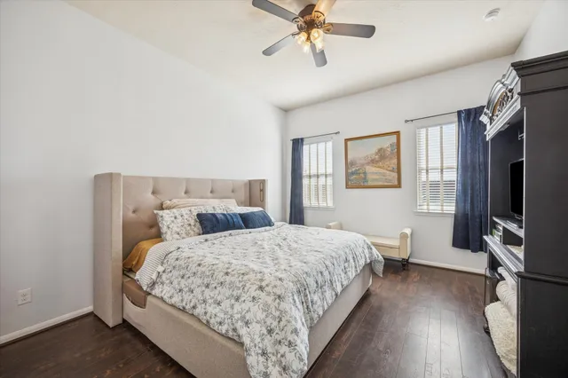 a bedroom with a bed flat screen tv and window