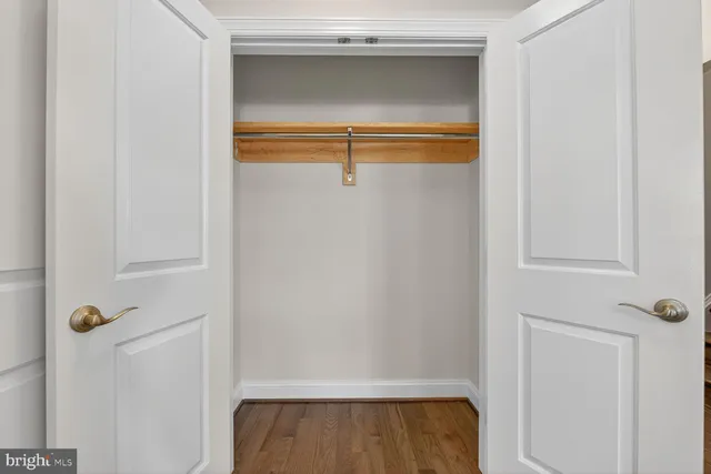 a kitchen with stainless steel appliances granite countertop white cabinets and a stove