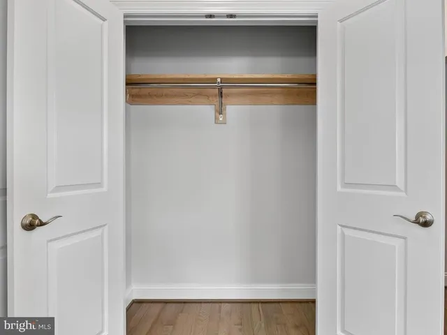 a kitchen with stainless steel appliances granite countertop a sink a stove and a wooden floors