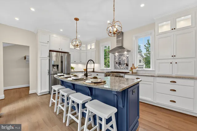 a view of a room with wooden floor furniture and windows