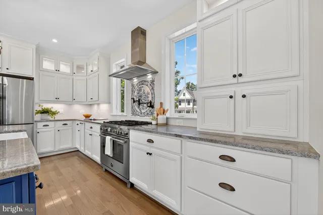 a utility room with cabinets washer and dryer