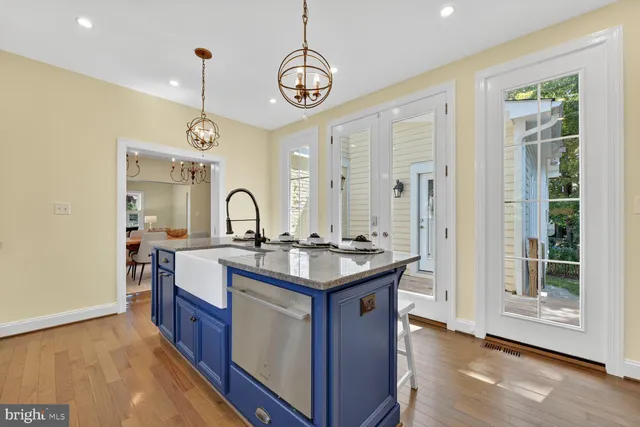 a view of a hallway with wooden floor and a bathroom