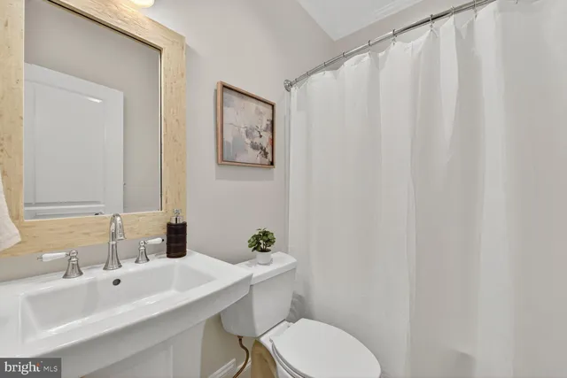 a kitchen with stainless steel appliances granite countertop a stove a sink a microwave a dining table and chairs with wooden floor