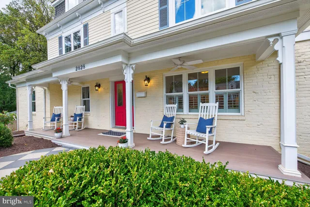 a view of a dining room with furniture a chandelier and wooden floor
