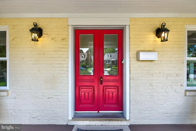 a view of a dining room with furniture a chandelier and wooden floor