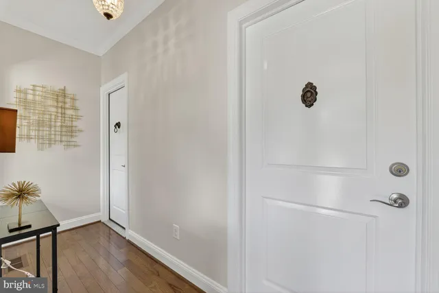 a view of a dining room with furniture a chandelier and wooden floor