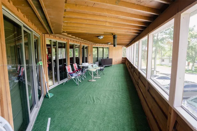 a view of a porch with wooden floor