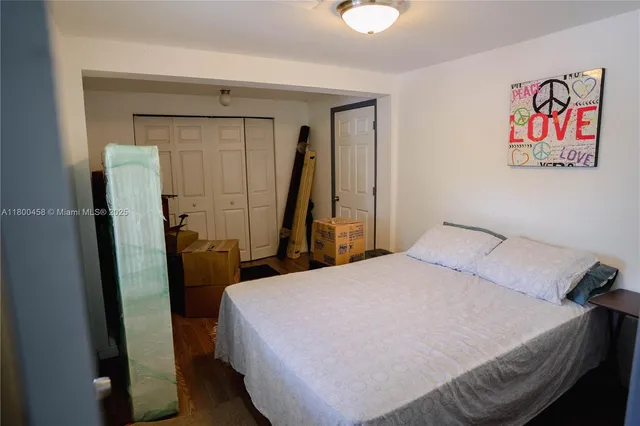 a bedroom with a bed and a mirror