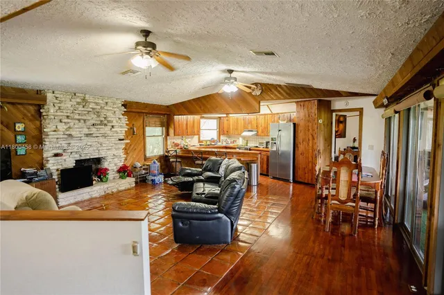 a living room with fireplace furniture and a wooden floor