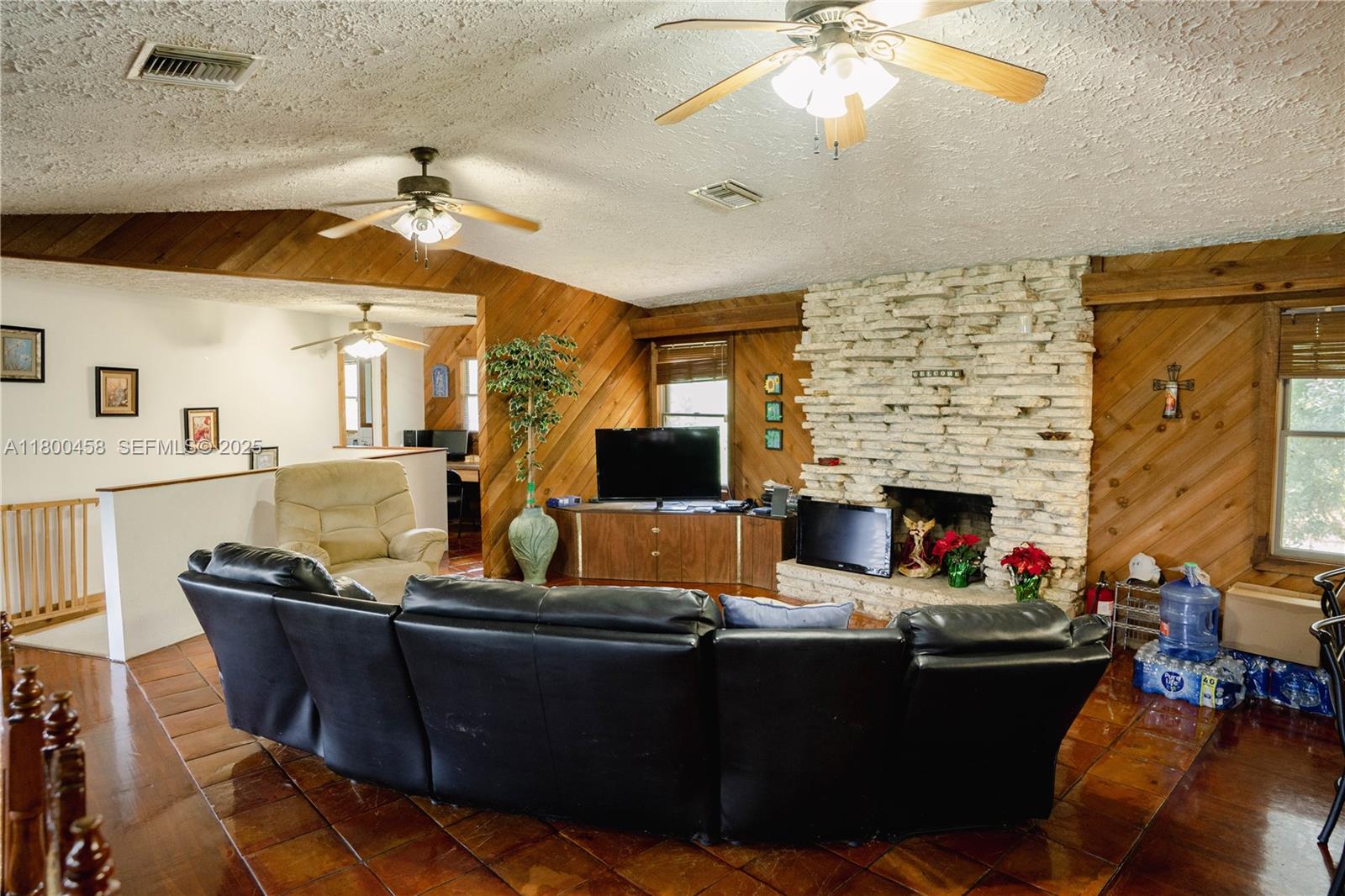 North Okeechobee Okeechobee, FL 34972 - Photo 10 of 23 a living room with furniture a fireplace and a chandelier