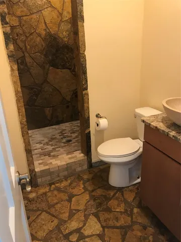 a bathroom with a toilet and a shower