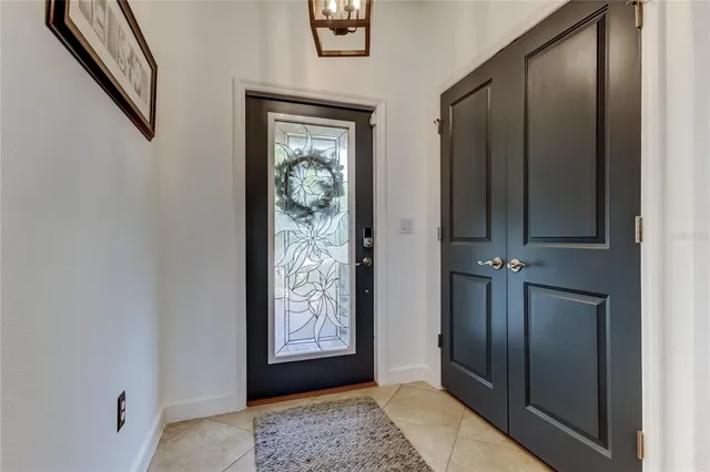 a kitchen with stainless steel appliances granite countertop a stove a refrigerator a oven a sink with a dining table and chairs