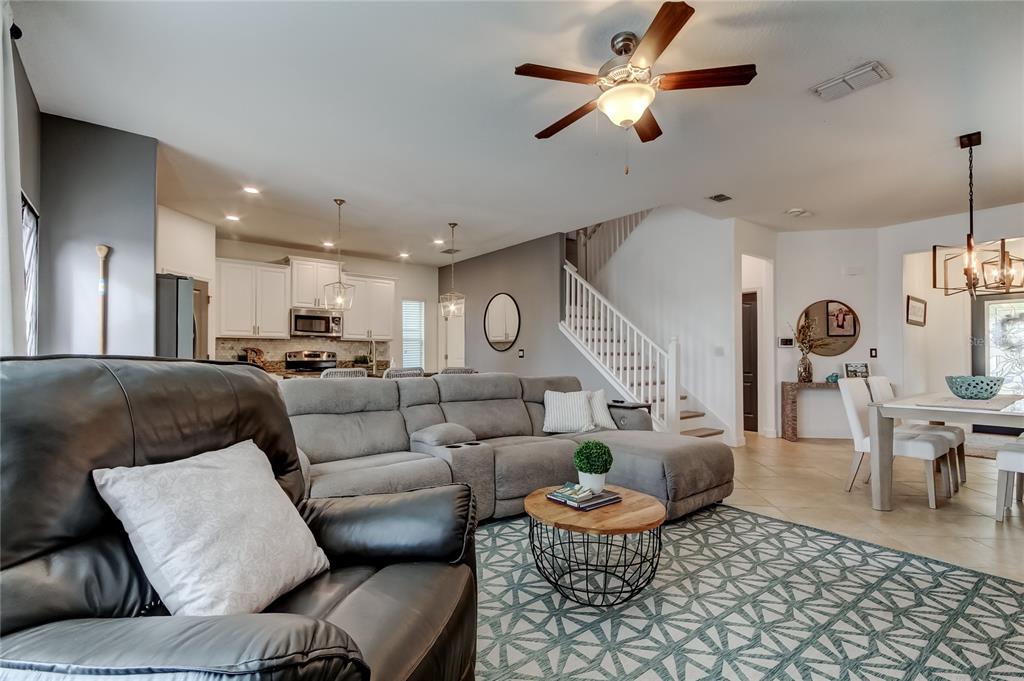 10141 Newminster Loop Ruskin, FL 33573 - Photo 18 of 77 a living room with furniture and a chandelier