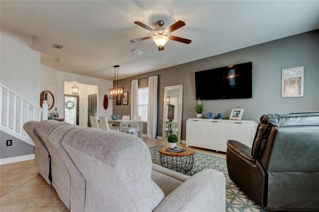 10141 Newminster Loop Ruskin, FL 33573 - Photo 19 of 77 a living room with furniture and a flat screen tv