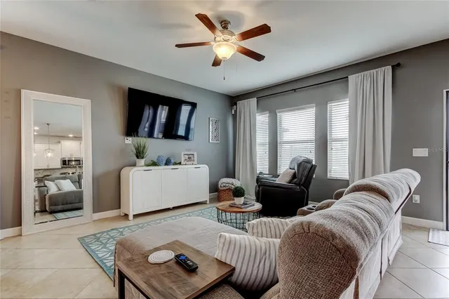 a bedroom with a bed and a lamp on dresser