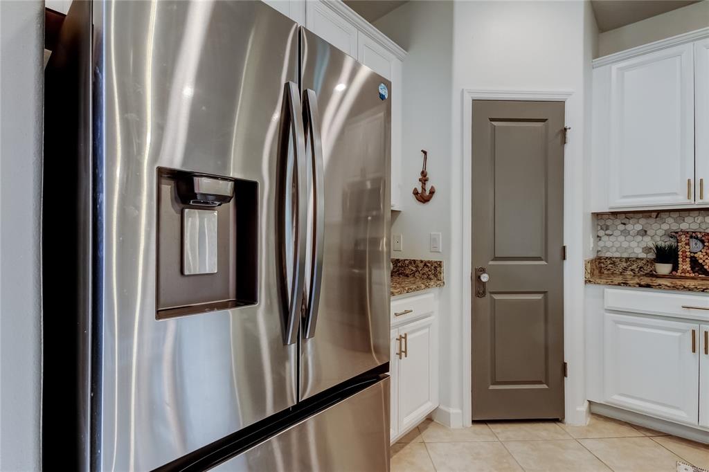 10141 Newminster Loop Ruskin, FL 33573 - Photo 26 of 77 a view of a kitchen with a refrigerator and cabinets