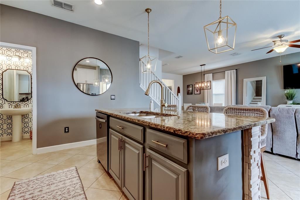 10141 Newminster Loop Ruskin, FL 33573 - Photo 29 of 77 a kitchen with cabinets and chandelier