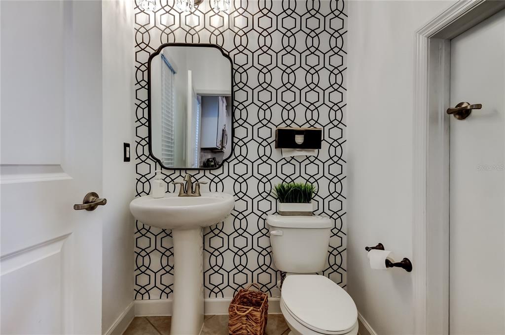 10141 Newminster Loop Ruskin, FL 33573 - Photo 32 of 77 a bathroom with a toilet sink and mirror