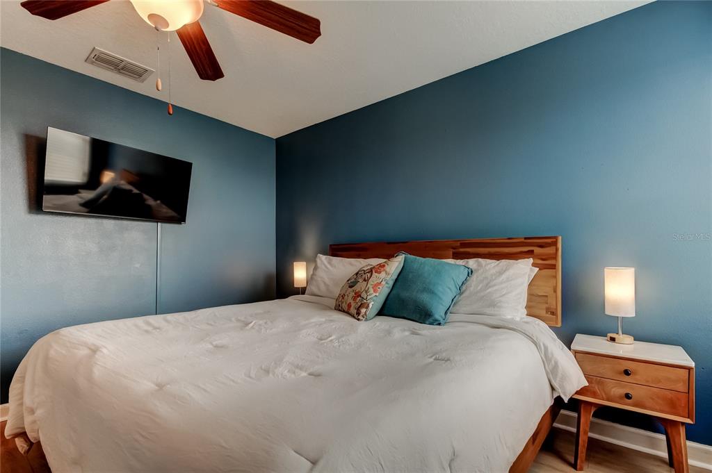 10141 Newminster Loop Ruskin, FL 33573 - Photo 36 of 77 a bedroom with a bed and a flat screen tv