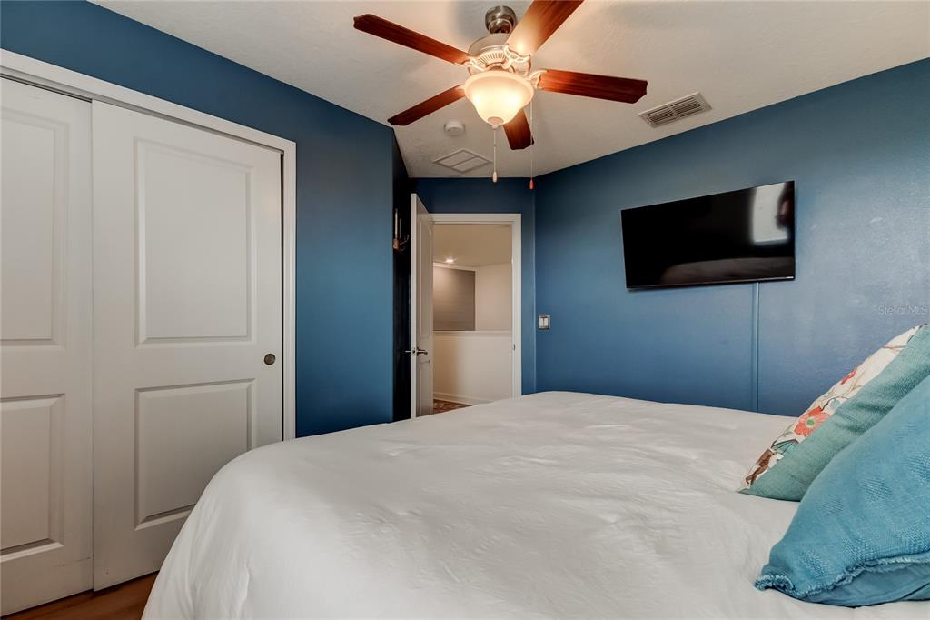 10141 Newminster Loop Ruskin, FL 33573 - Photo 37 of 77 a bedroom with a bed and a flat screen tv