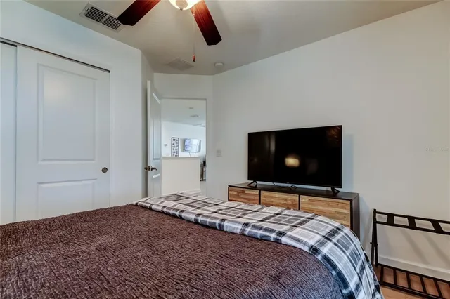 a kitchen with stainless steel appliances granite countertop a stove top oven a sink a dining table and chairs with wooden floor