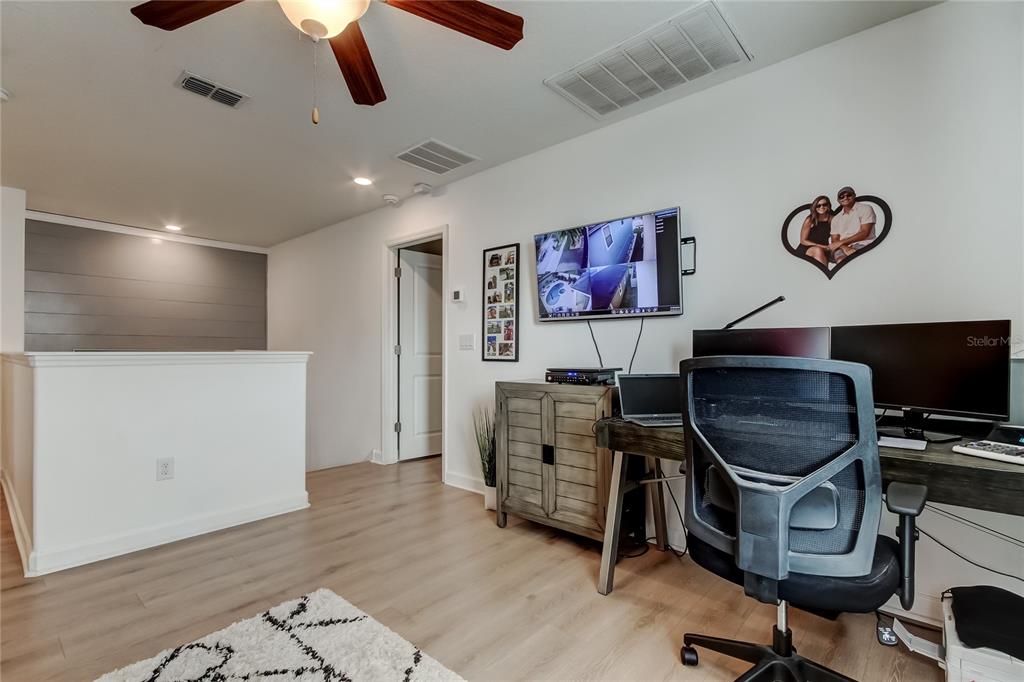 10141 Newminster Loop Ruskin, FL 33573 - Photo 48 of 77 a room with furniture and a flat screen tv