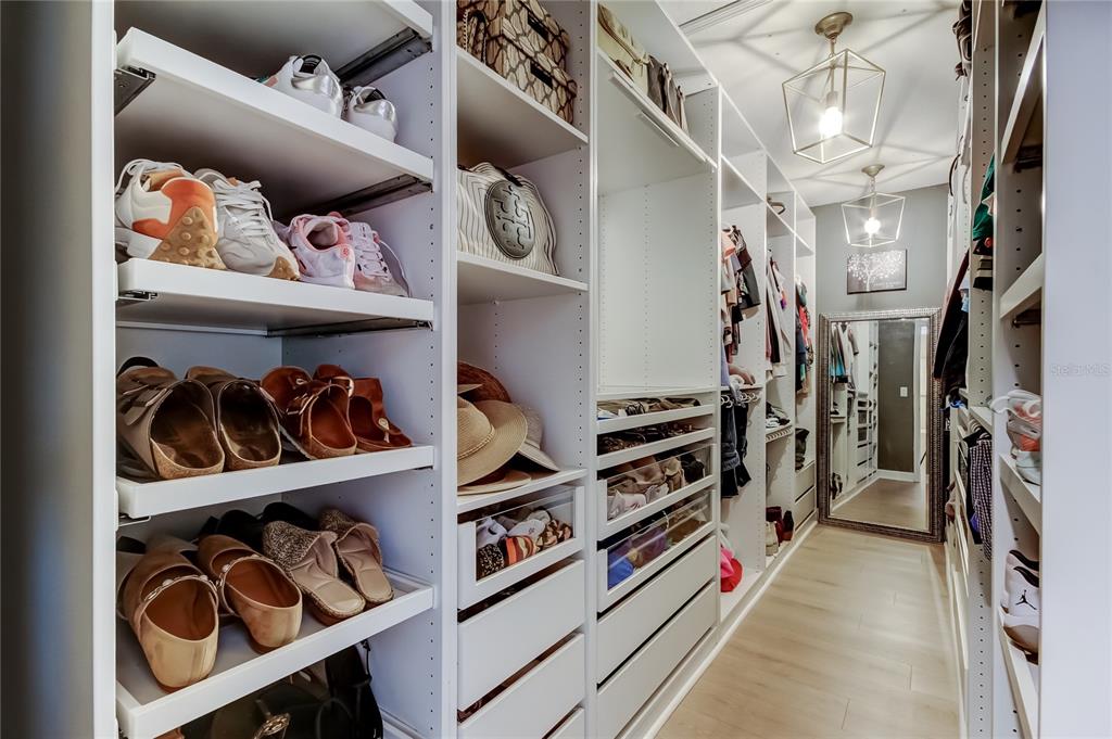 10141 Newminster Loop Ruskin, FL 33573 - Photo 50 of 77 a view of walk in closet with clothes and shoes