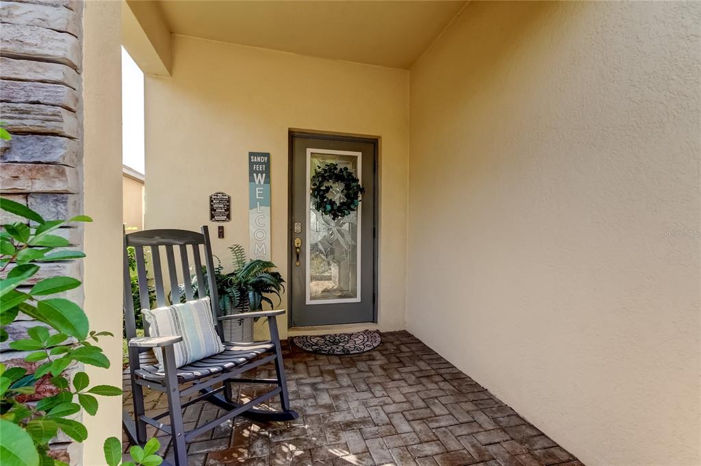 10141 Newminster Loop Ruskin, FL 33573 - Photo 10 of 77 a view of a hallway with wooden floor and a potted plant
