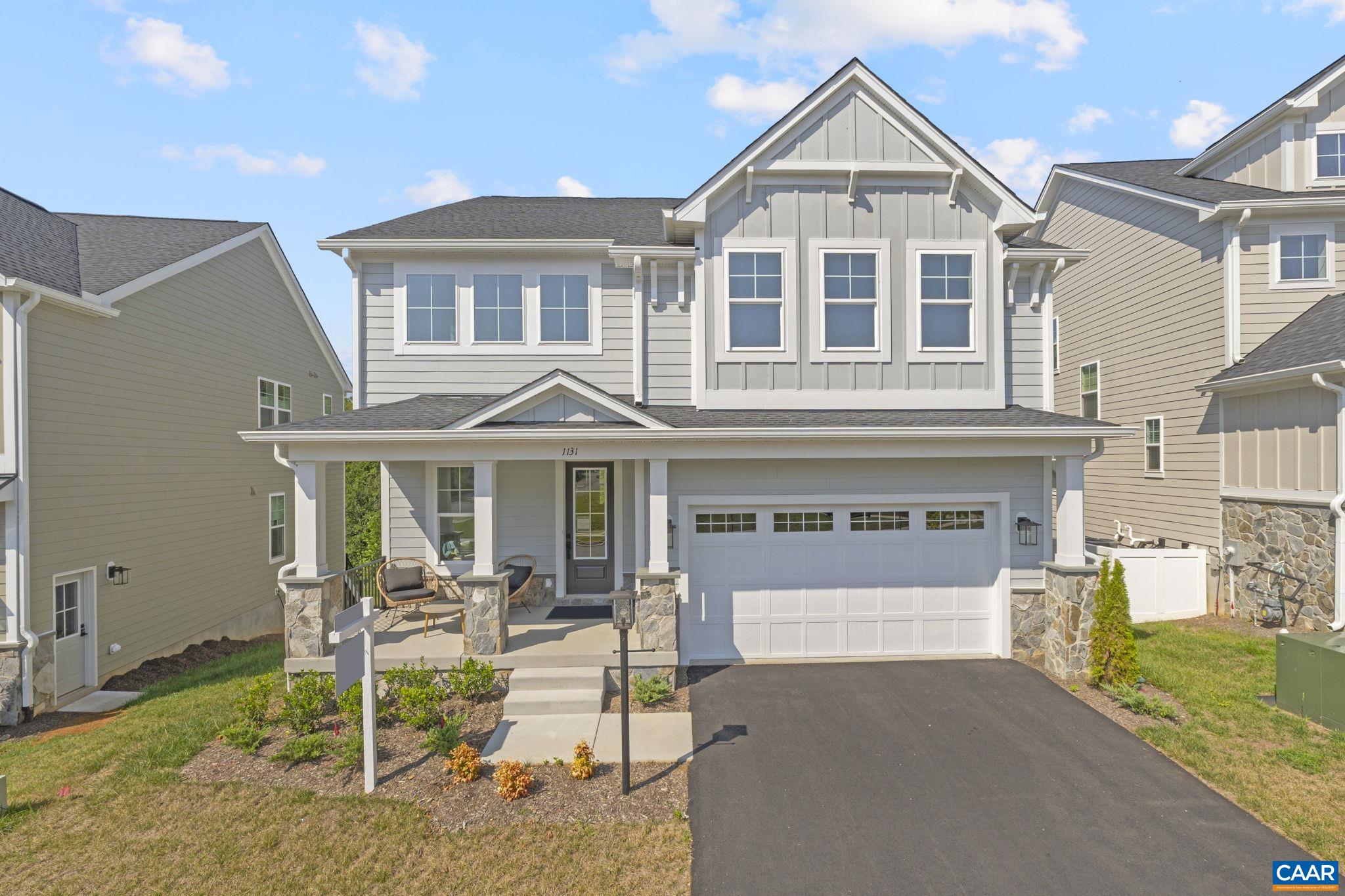 114 D Marcella Street Charlottesville, VA 22911 - Photo 1 of 58 a view of a white house with a yard and lawn chairs