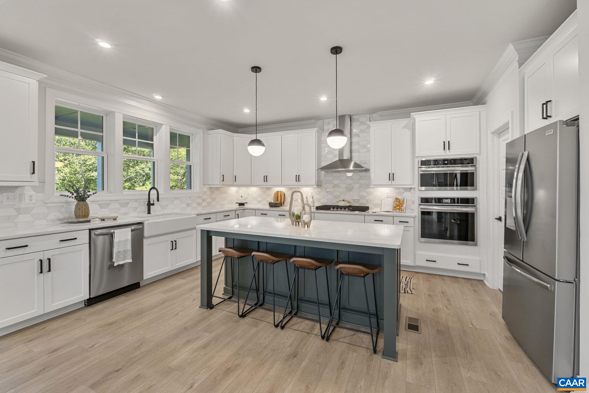 114 D Marcella Street Charlottesville, VA 22911 - Photo 19 of 58 a kitchen with stainless steel appliances kitchen island granite countertop a table chairs stove and refrigerator