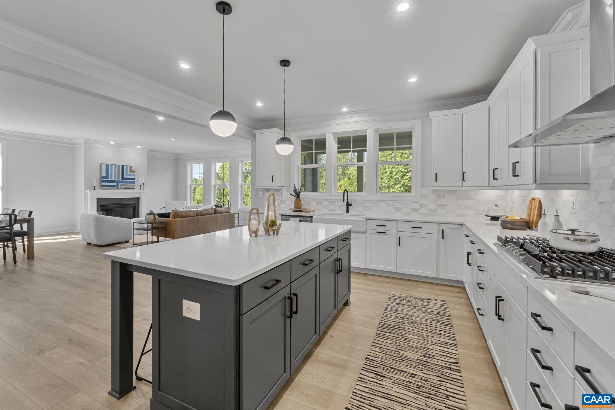 114 D Marcella Street Charlottesville, VA 22911 - Photo 20 of 58 a kitchen with a stove a sink a center island and a window