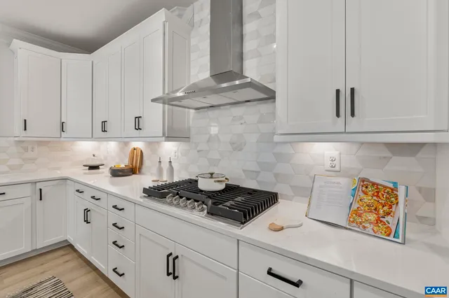 a kitchen with stainless steel appliances a sink a stove and a window