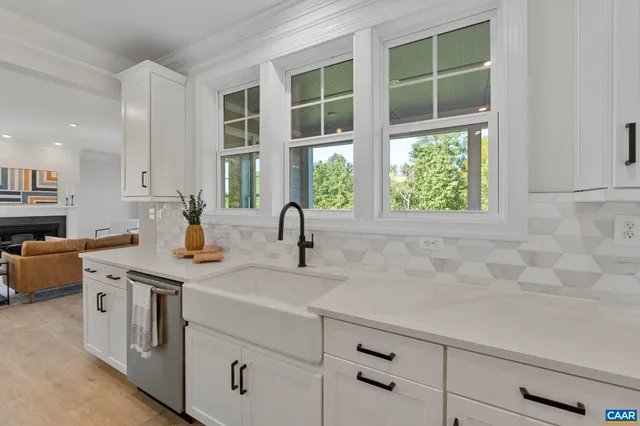 a kitchen with granite countertop white cabinets and white appliances