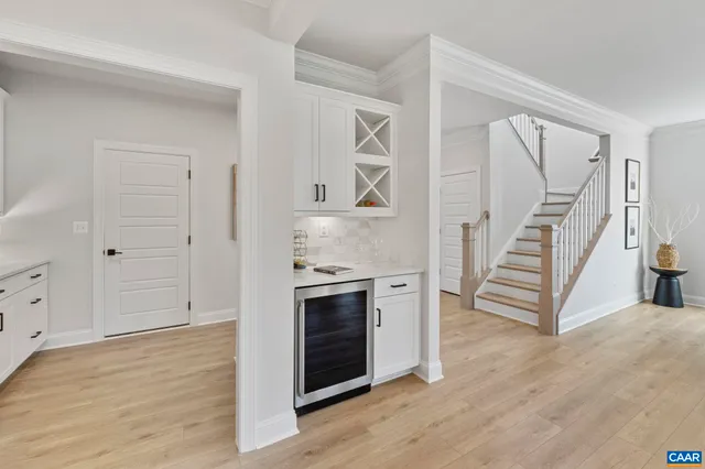 a kitchen with white cabinets and white appliances