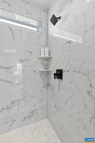 a view of a hallway with wooden floor and entryway