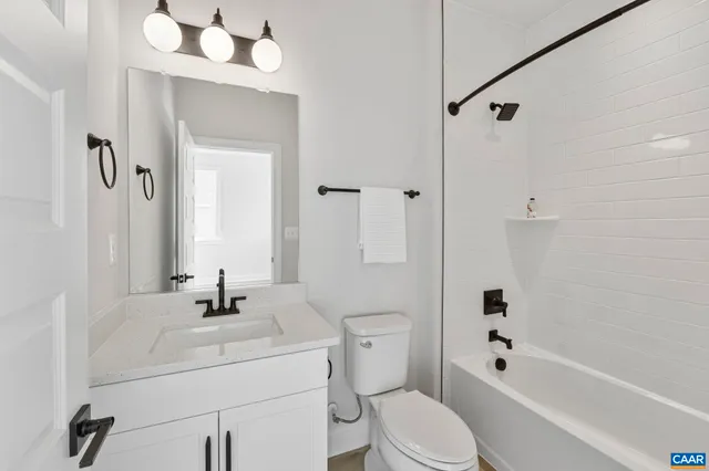 a bathroom with a sink a mirror and a shower