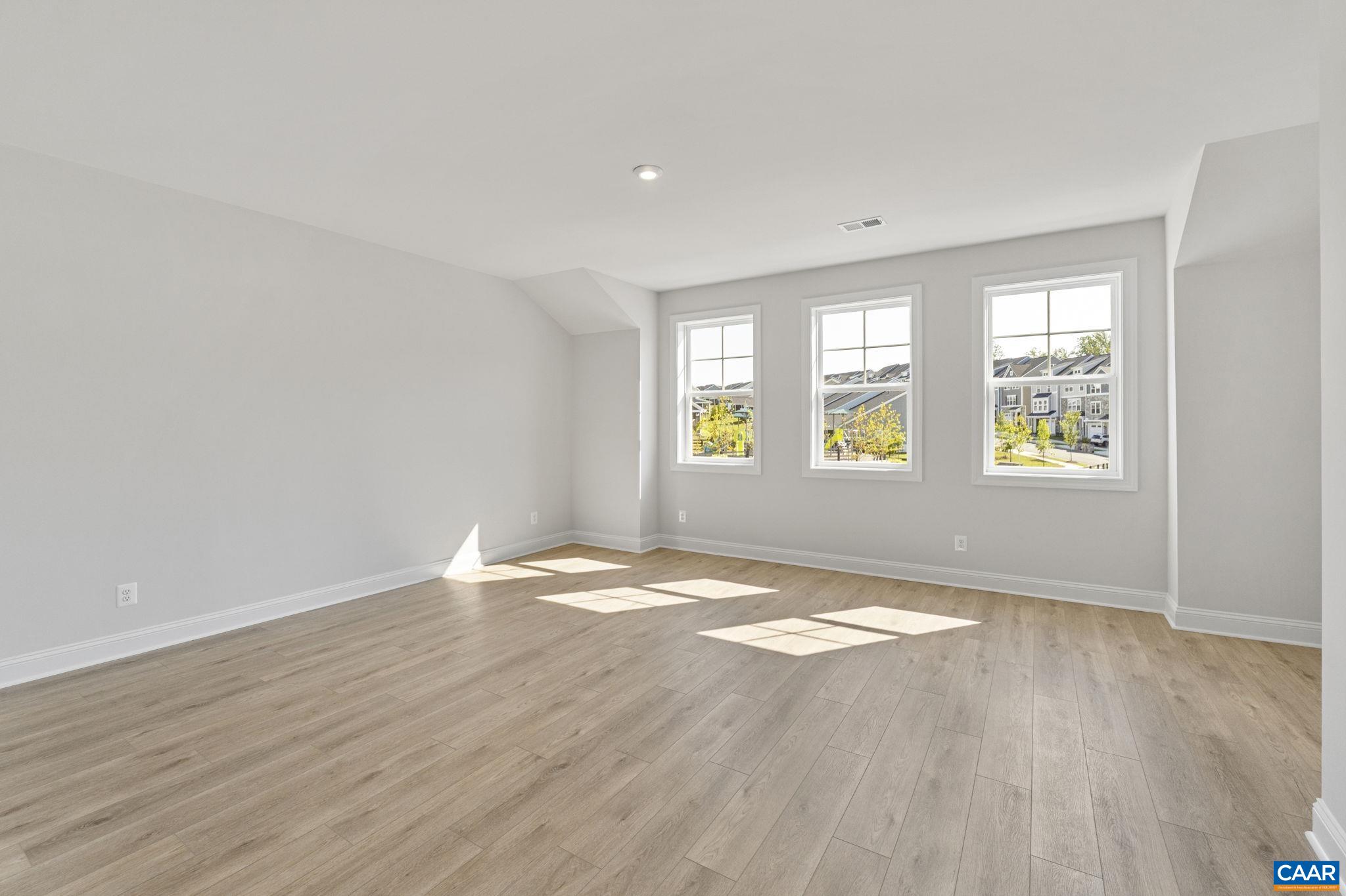 114 D Marcella Street Charlottesville, VA 22911 - Photo 41 of 58 an empty room with wooden floor and windows