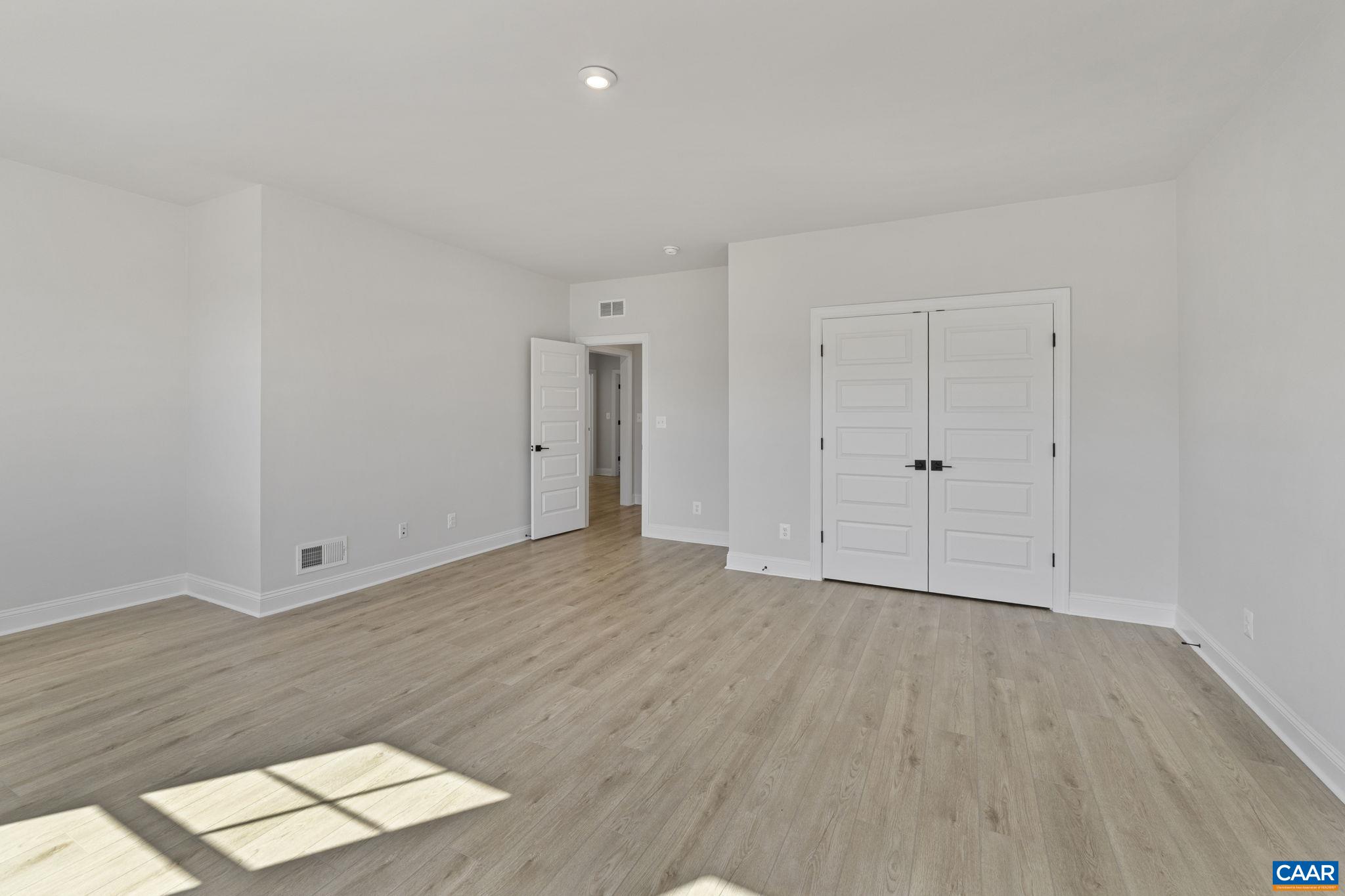 114 D Marcella Street Charlottesville, VA 22911 - Photo 42 of 58 a view of an empty room with wooden floor