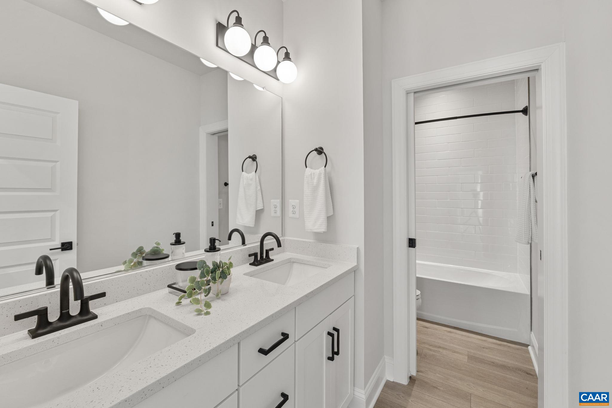 114 D Marcella Street Charlottesville, VA 22911 - Photo 43 of 58 a bathroom with a sink a mirror and a shower