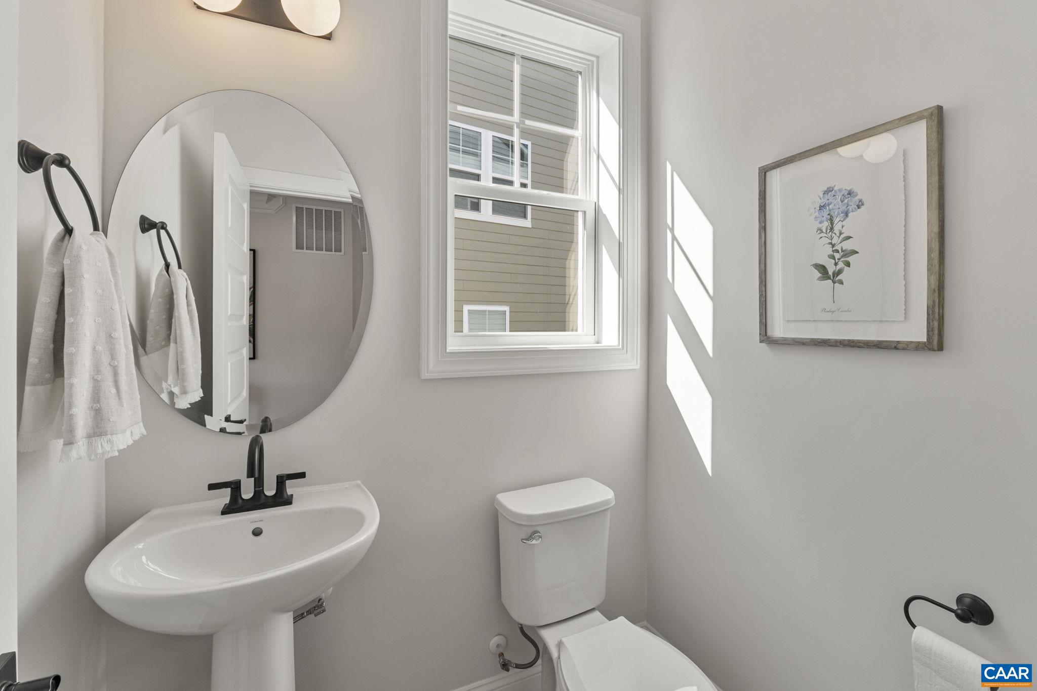 114 D Marcella Street Charlottesville, VA 22911 - Photo 8 of 58 a bathroom with a toilet sink and mirror