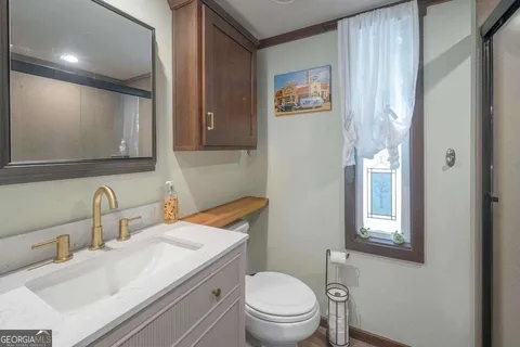 a bathroom with a toilet a sink and shower