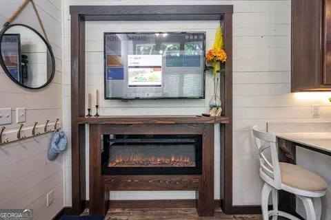 a view of a livingroom with furniture hardwood floor and a fireplace