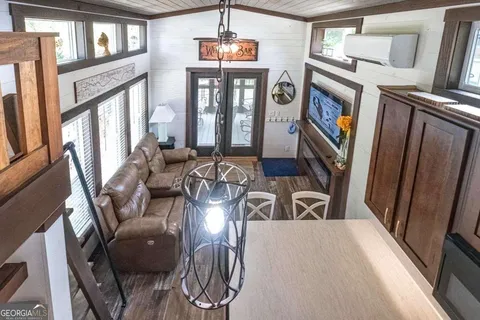 a spacious bedroom with a bed and a chandelier
