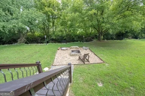 a view of a deck and trees in the background
