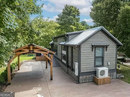 a view of a house with a yard patio and a garden