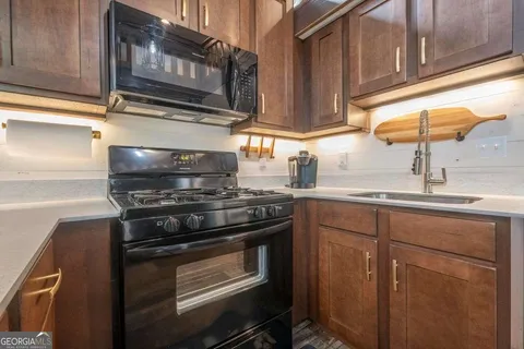 a kitchen with stainless steel appliances granite countertop a stove and a sink