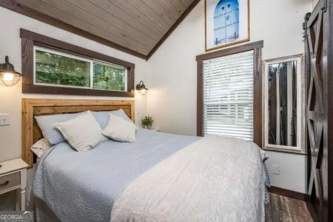 a bedroom with a large bed and a window