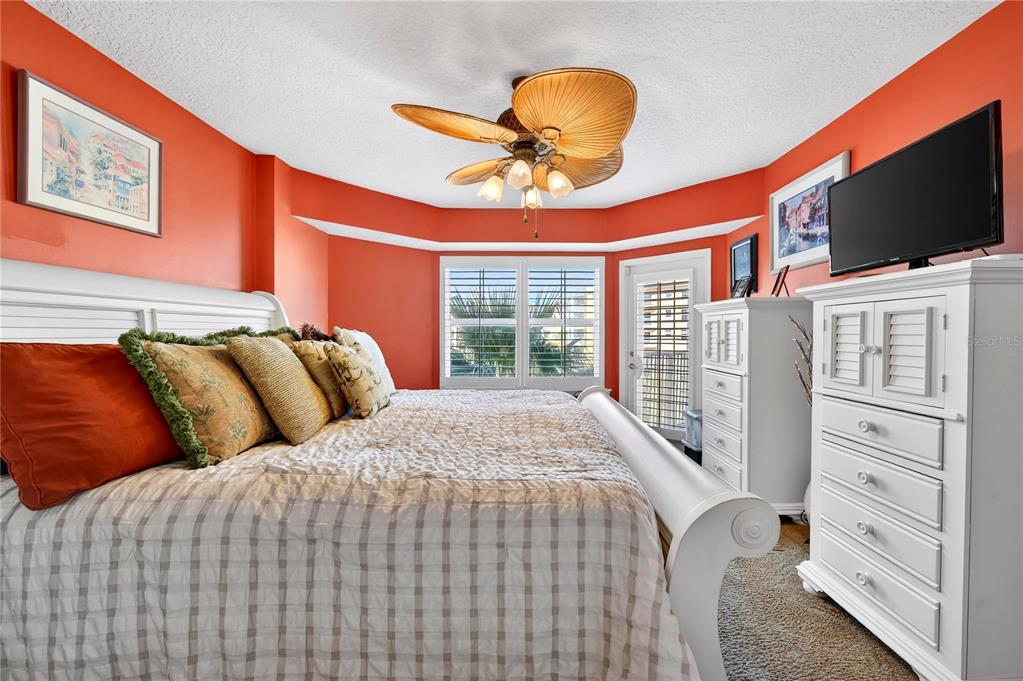 4670 Links Village Drive, Unit D506 Ponce Inlet, FL 32127 - Photo 18 of 60 a bedroom with bed tv and window